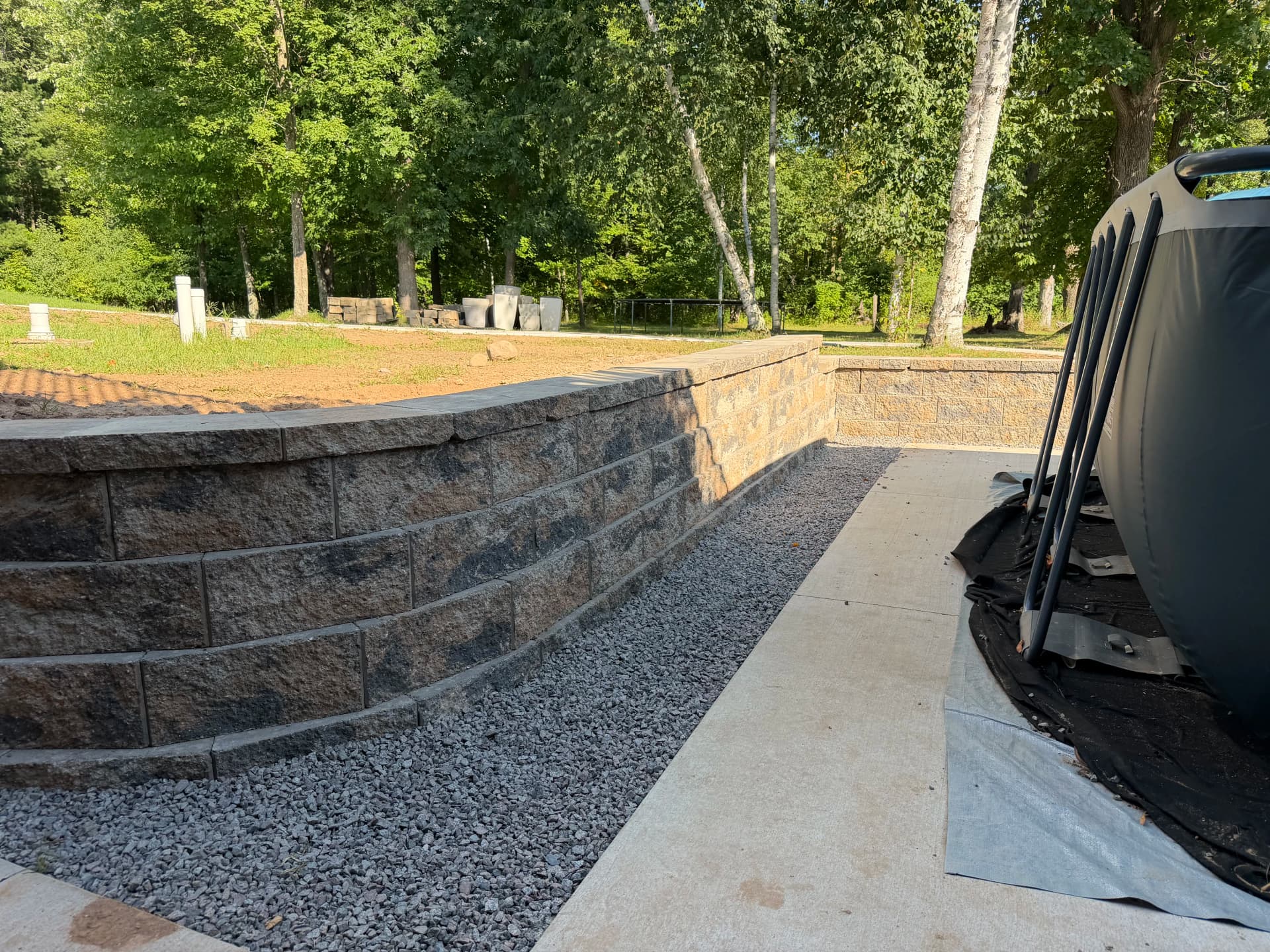 Old Retaining Walls Replaced With Two Solid New Ones Around Pool and Patio